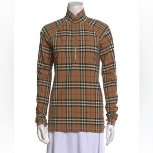 Burberry stretch jersey turtleneck top with a half-zip closure and thumb holes